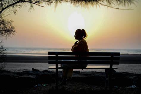 women sitting on bench alone Effects of Being Single