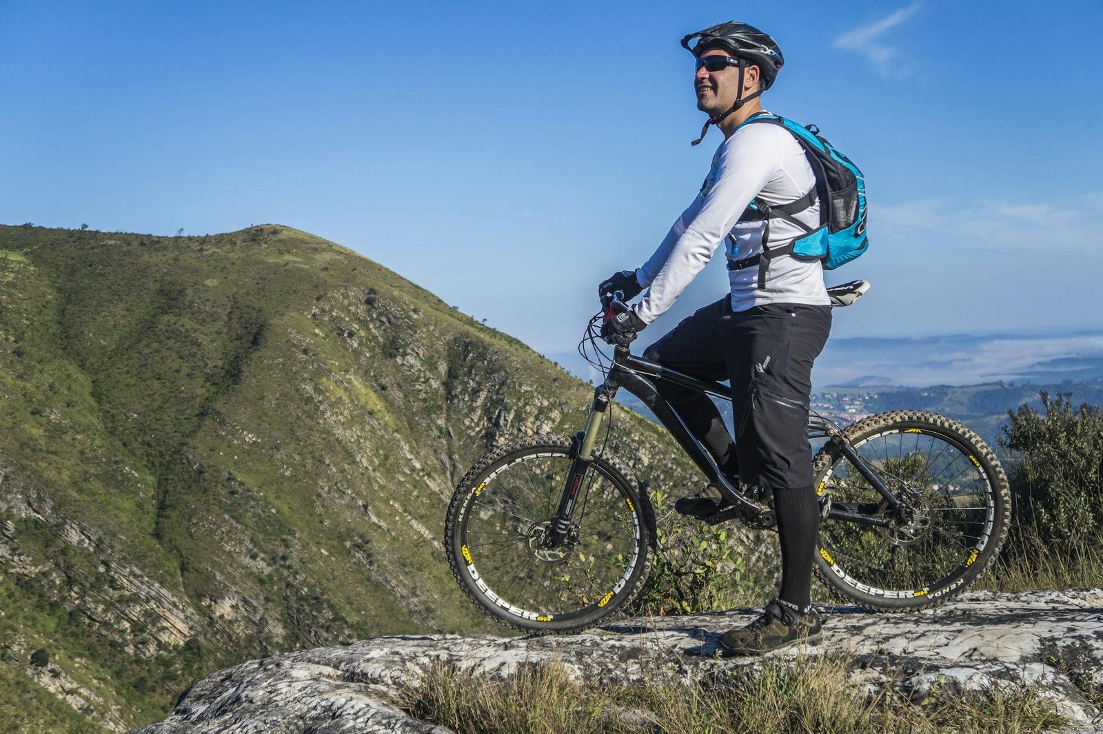man with white shirt riding a bicycle on a mountain Low-Impact Cardio Moves