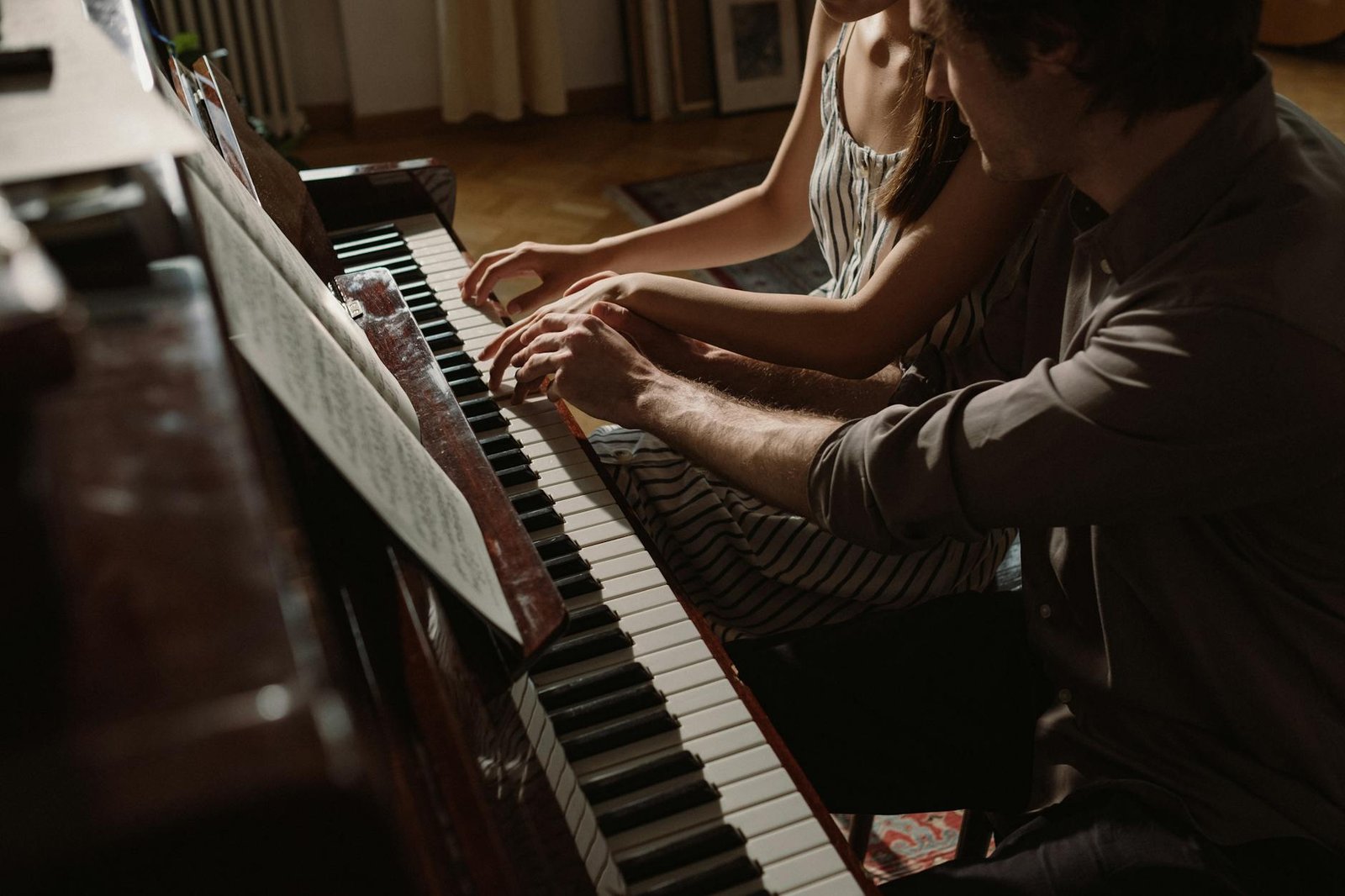couple playing on piano