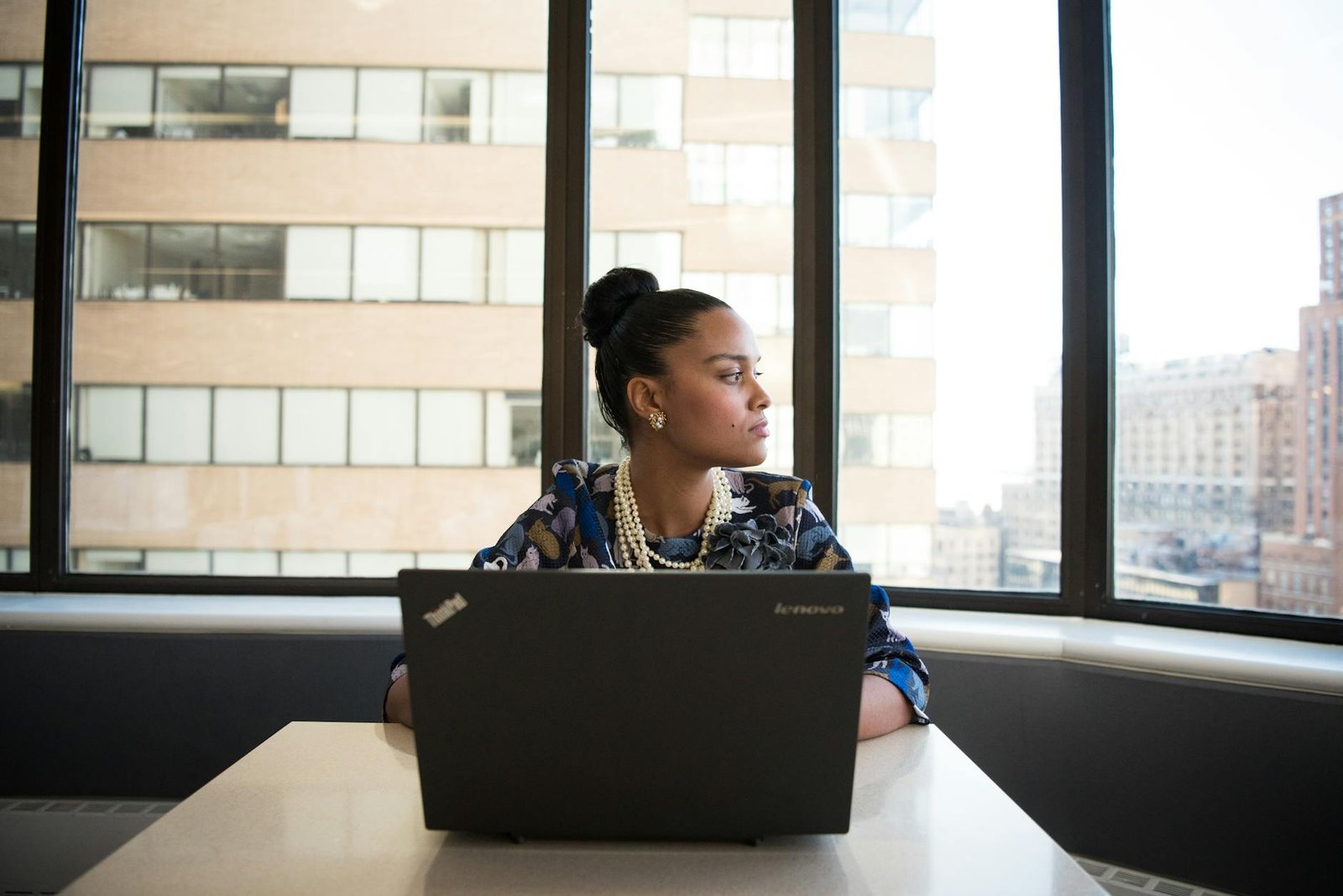 woman sits in front of black laptop computer Beat Overwhelm at Work