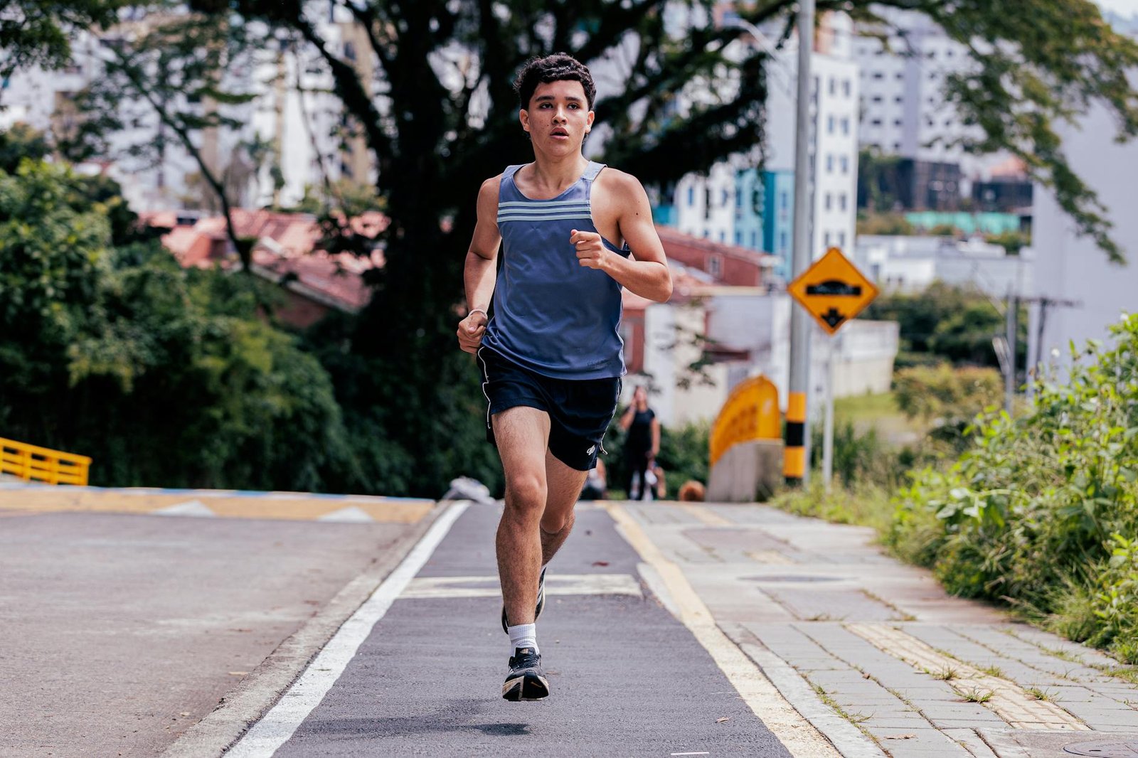 young man running on city street in summer Low-Impact Cardio Moves