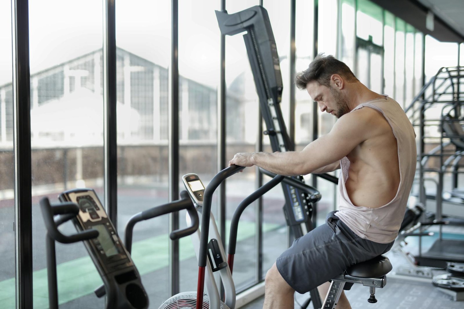 strong sportsman using exercise bike in gym Low-Impact Cardio Moves