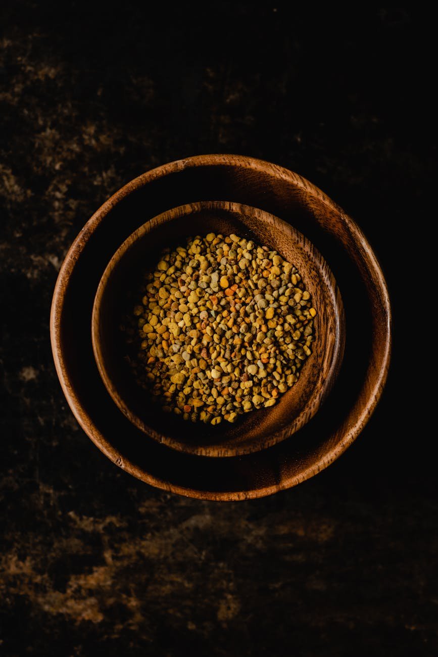 a top view of bee pollen in a wooden bowl