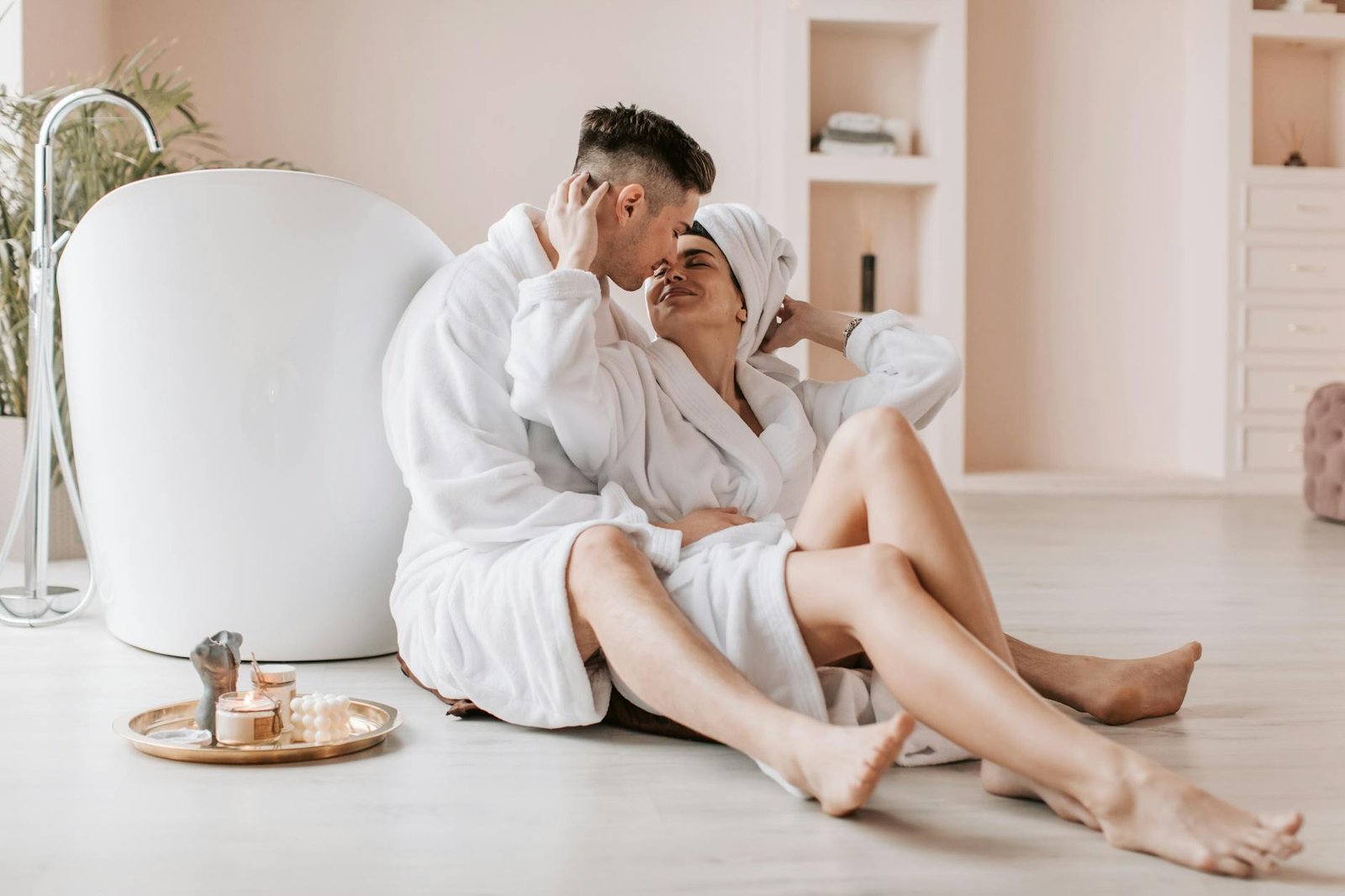 man and woman wearing bathrobes sitting on the floor