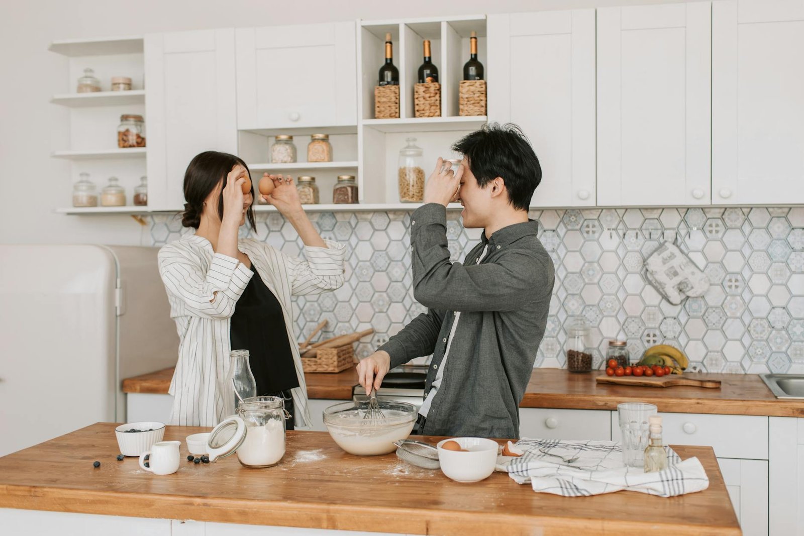 a couple preparing the ingredients in the kitchen