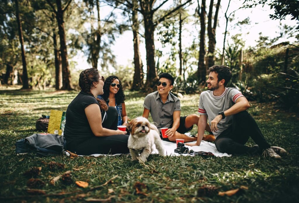 group of people sitting on white mat on grass field Strengthen Your Self-Worth