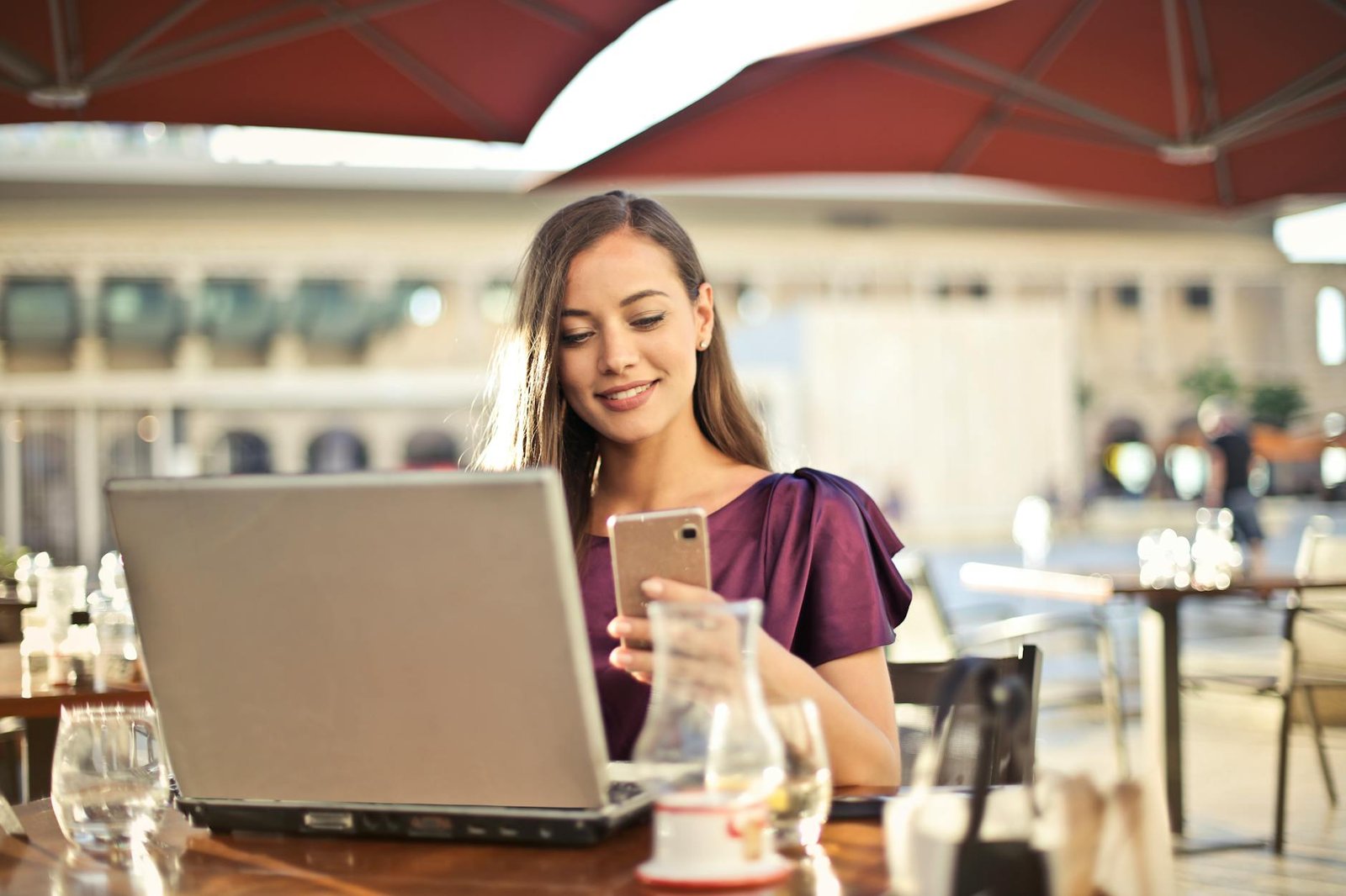 woman wearing purple shirt holding smartphone white sitting on chair How to Take Back Control at Work