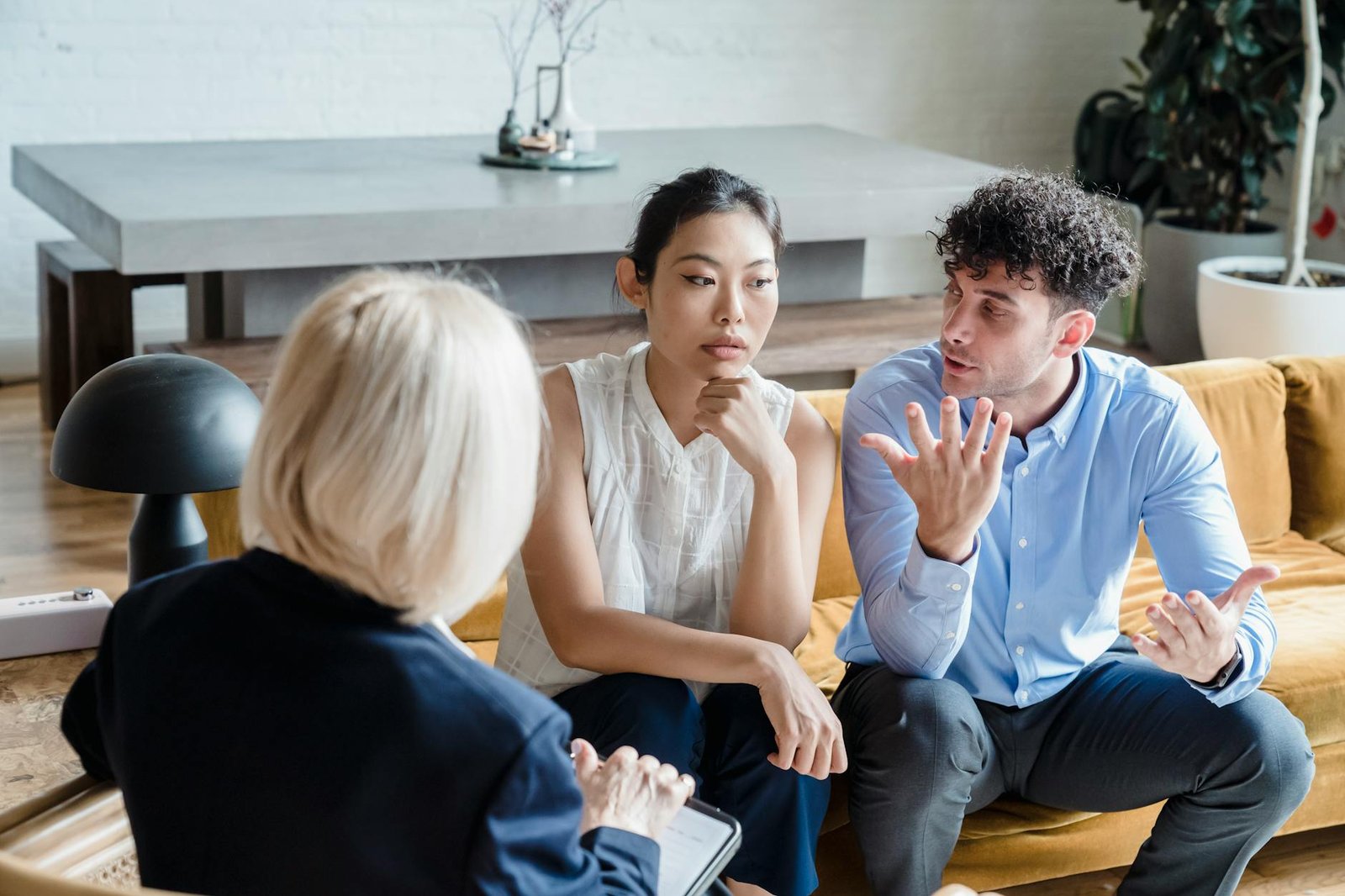 a couple having an argument in front of the person wearing black blazer