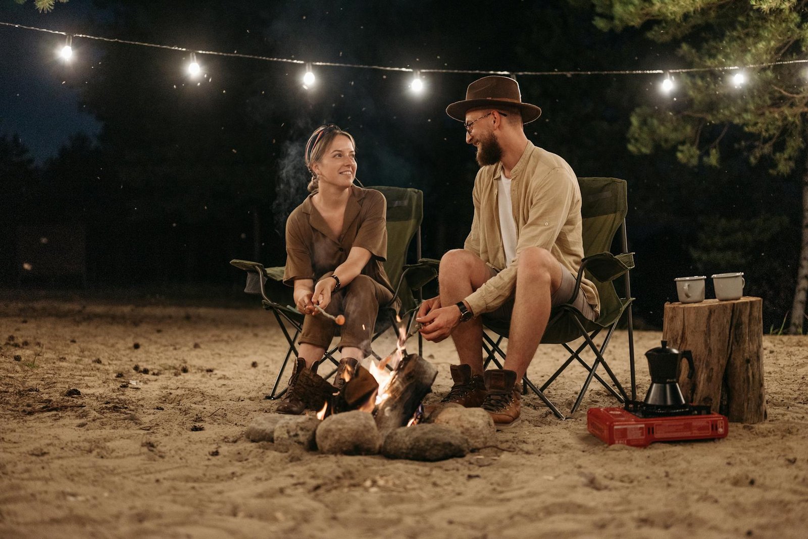 man and woman camping at night