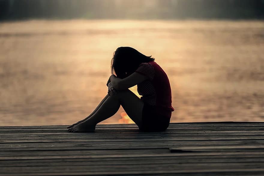 women setting alone with self thinking post Navigate a Relationship