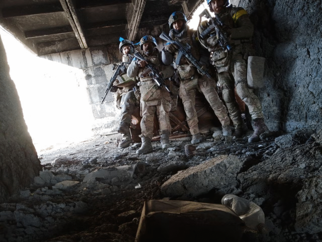 Team of solder inside a destroyed building holding their position